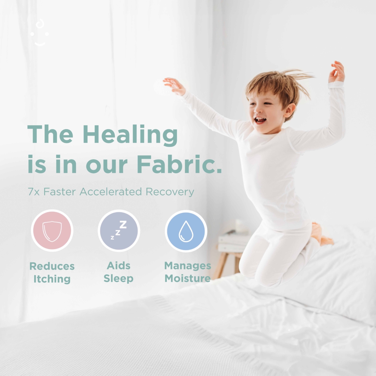 smiling boy jump on bed and wearing eczema pyjamas